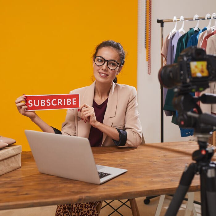 fashio-blogger-holding-subscribe-button-2023-11-27-05-08-55-utc (1)