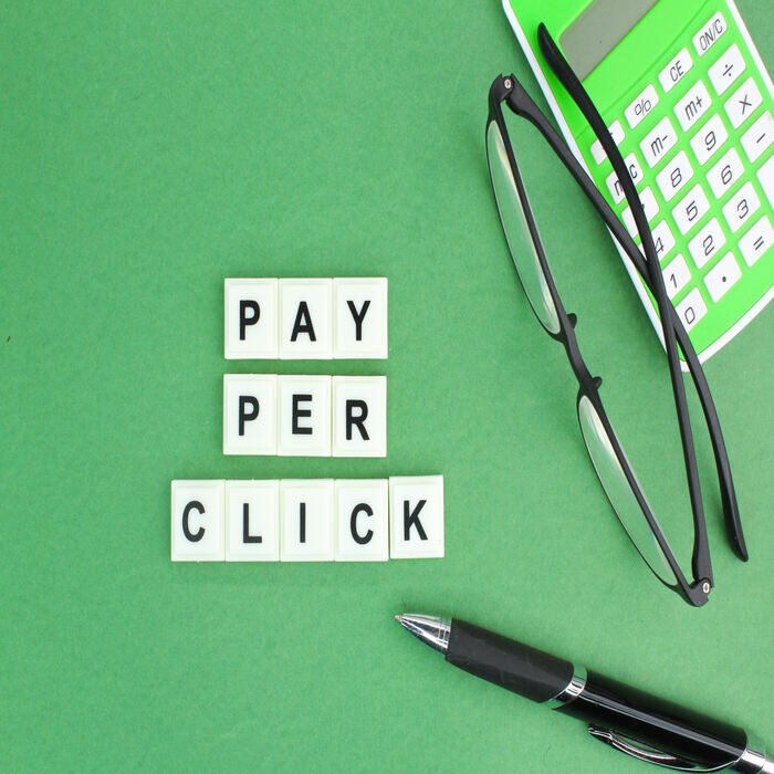 pen-glasses-and-a-calculator-with-the-word-pay-pe-2023-11-27-05-33-20-utc (1)